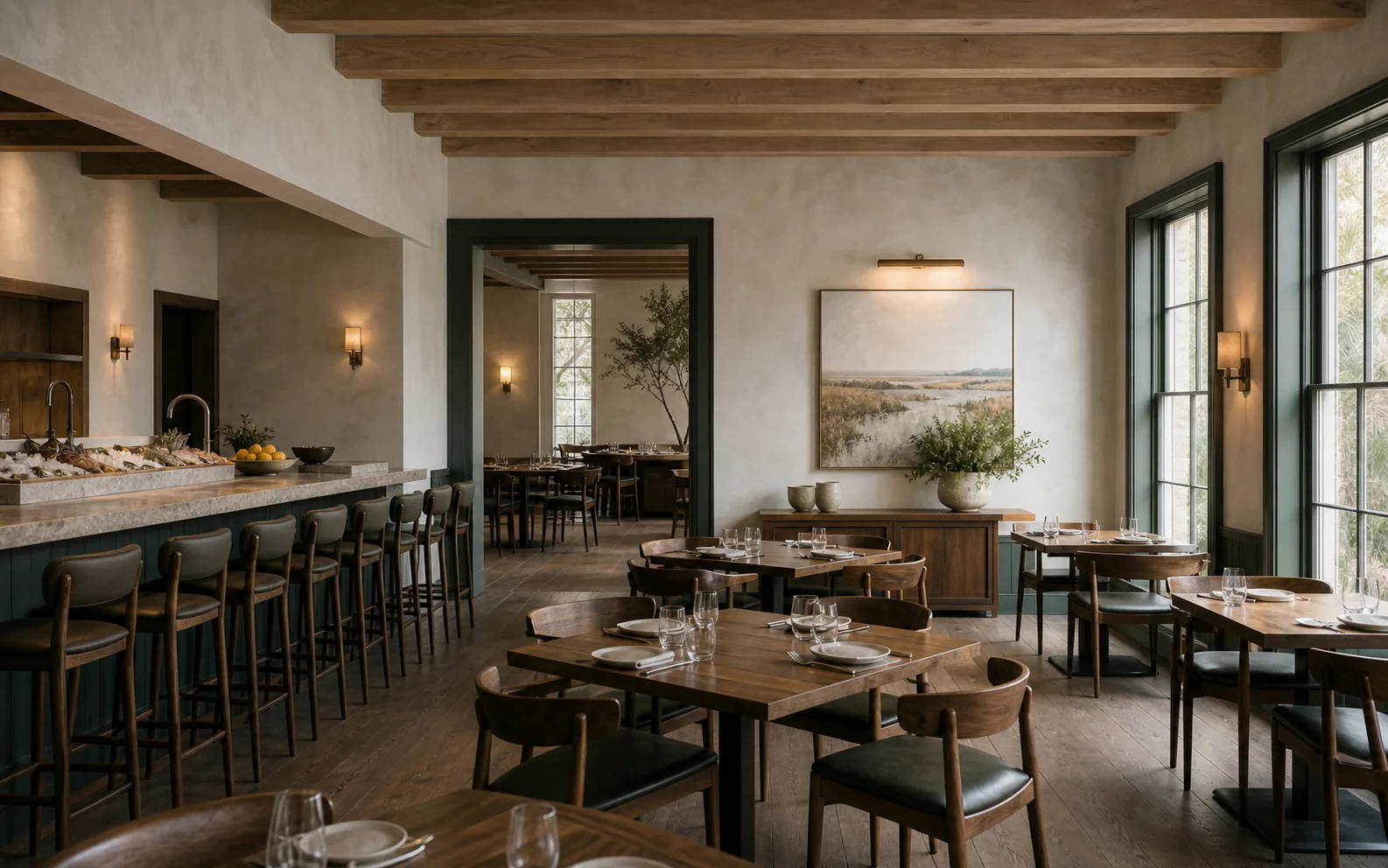 A coastal dining room with limewashed walls, warm oak beams, and a marsh-green oyster bar.